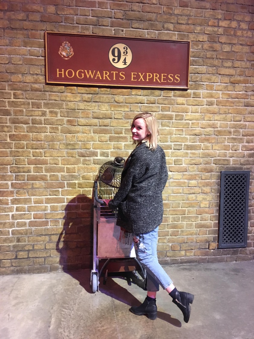 photo of Becky at the Harry Potter studios posing at platform 9 3/4